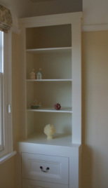 Fitted alcove cupboards.