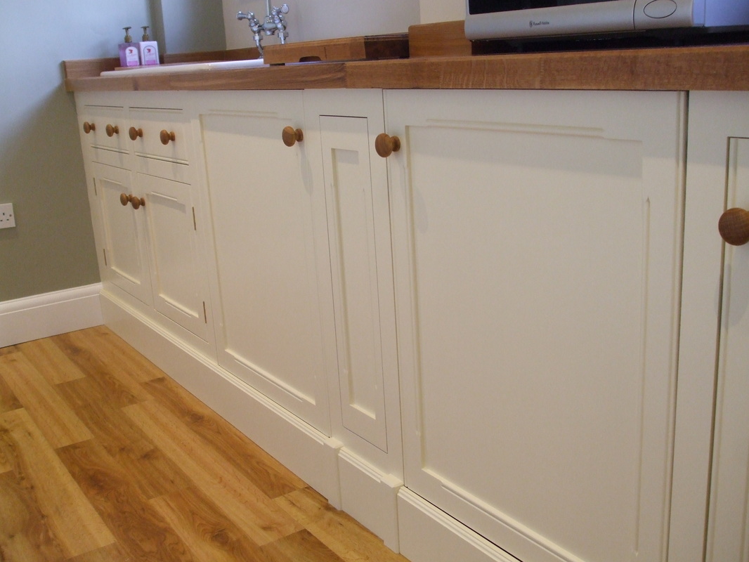 Painted utility kitchen with solid oak worktop.